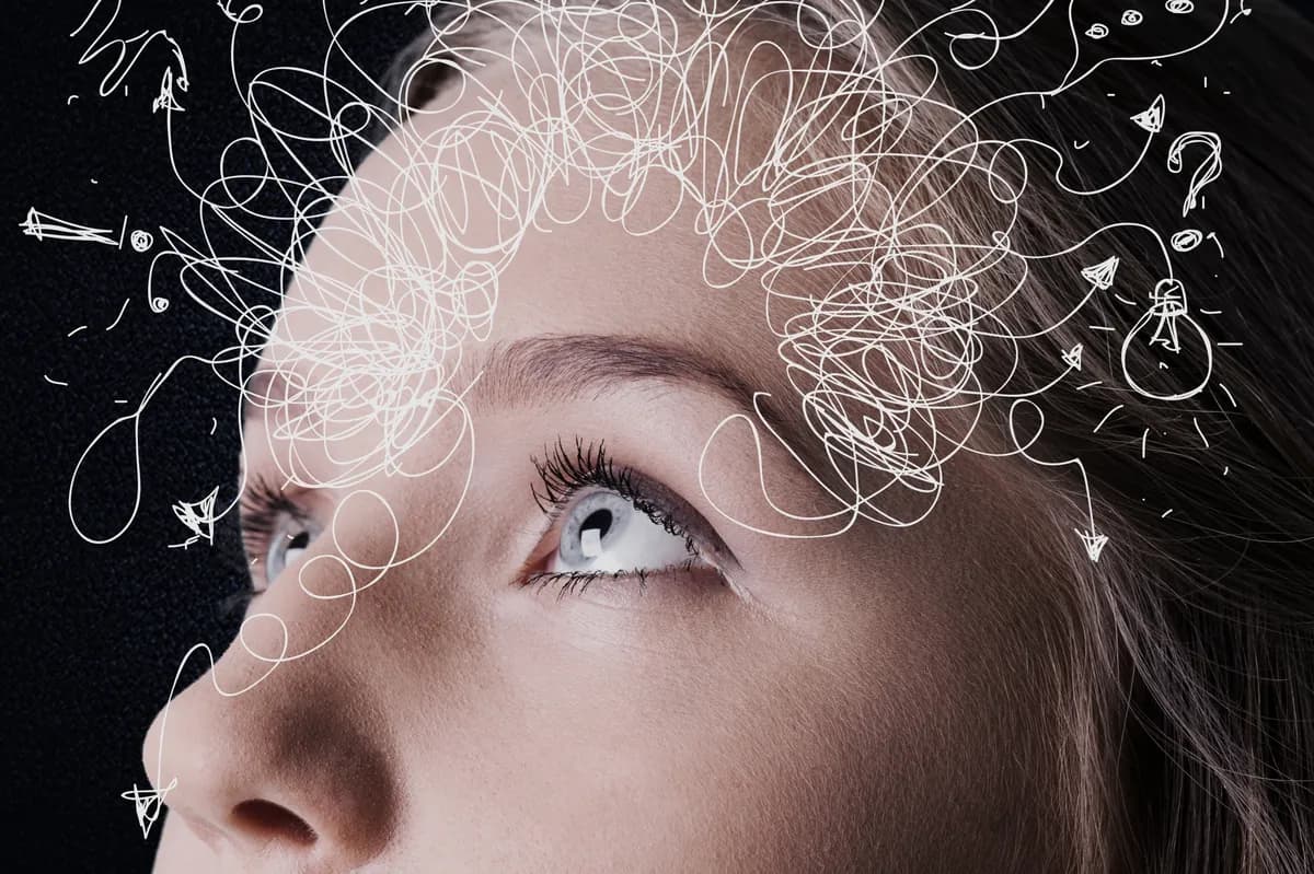 Close-up of a woman's face with scribbled lines suggesting tangled thoughts